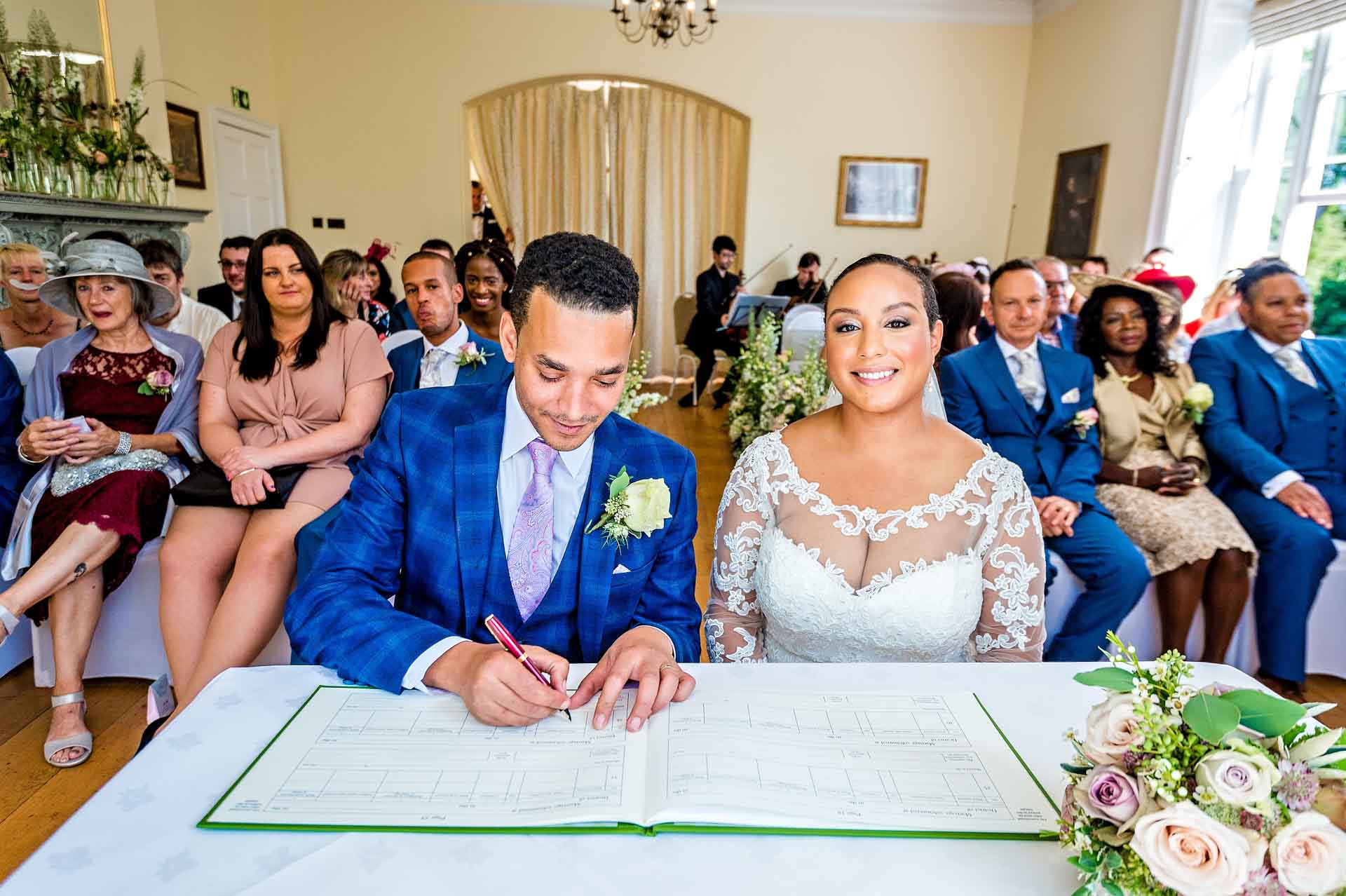 Groom Signing the Register in Russell Suite at Pembroke Lodge Wedding